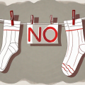 Compression stockings hanging on a clothesline with a red "no" symbol overlaying them