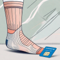 A pair of compression socks next to a french health insurance card